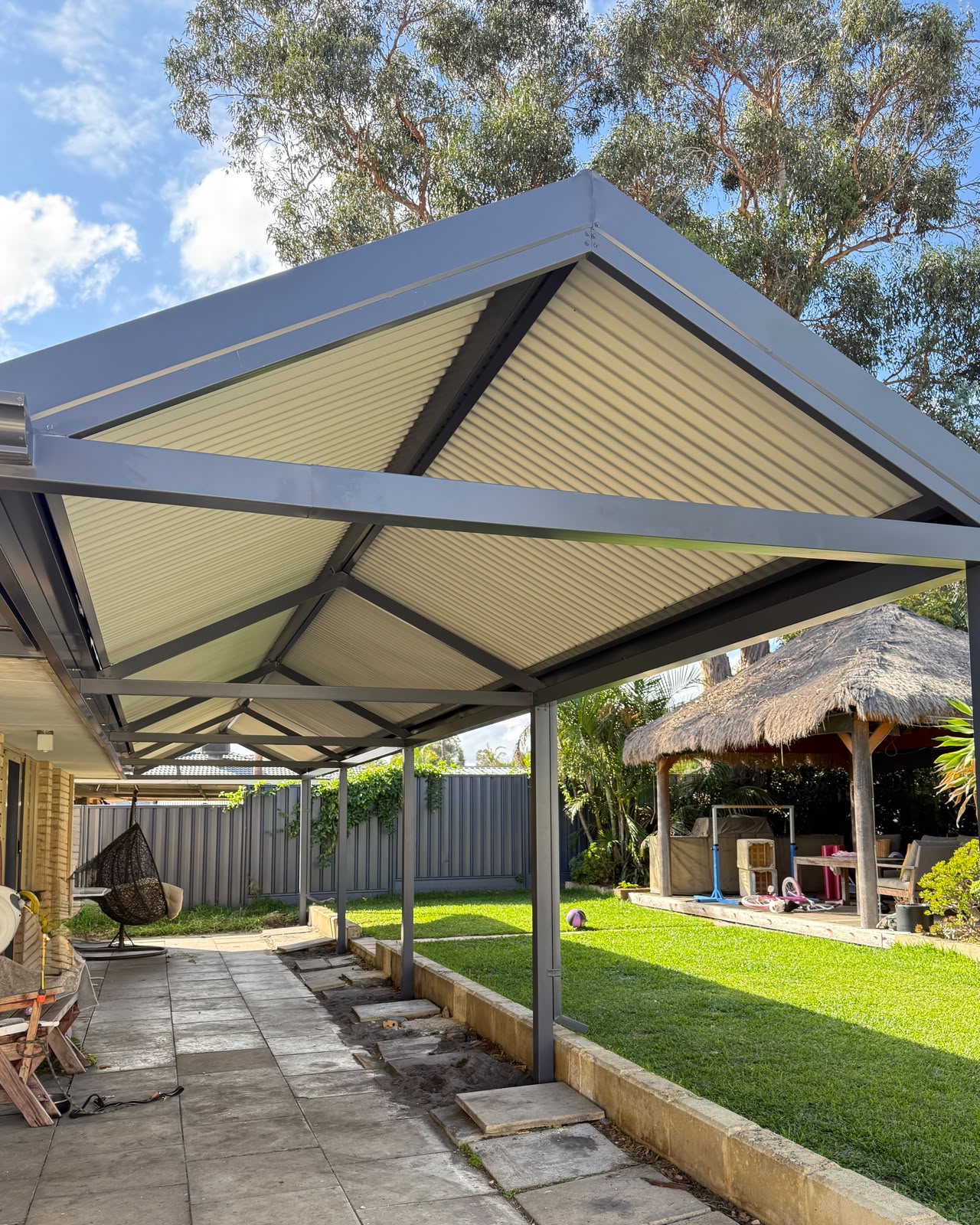 Gable pergola over a paved courtyard